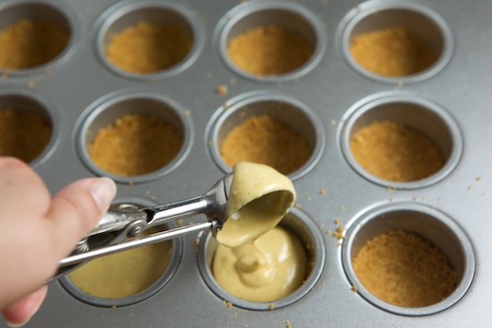 Adding filling for Mini Pumpkin Cheesecakes | pinchmysalt.com
