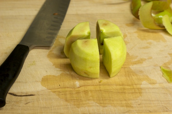 Now cut the apple into four quarters. I like to do this with the apple turned upside down.