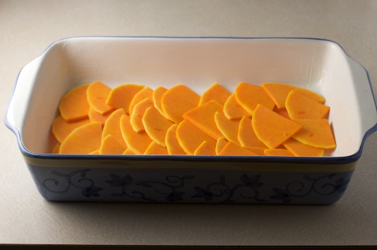 Use half of the butternut squash slices to form a single overlapping layer in the bottom of a greased 9x13 casserole dish (or use a similar sized gratin dish).