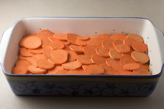 Now use half of the sliced sweet potatoes to form another single overlapping layer.