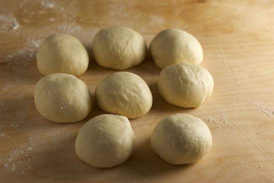 Eight Kaiser Rolls Ready for Shaping
