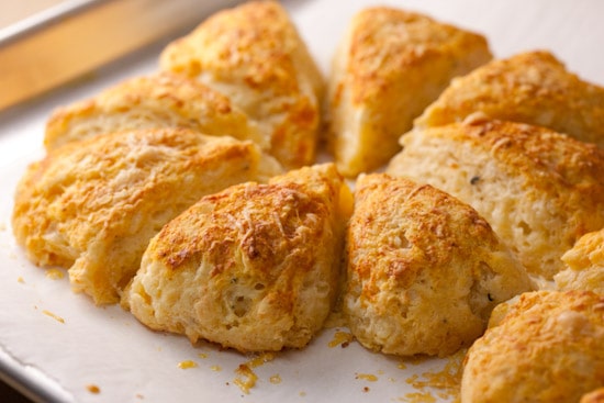 These savory cheddar scones made with buttermilk and brushed with smoked paprika butter are tender, flavorful, and easy to make. Perfect with soup or salad! | pinchmysalt.com