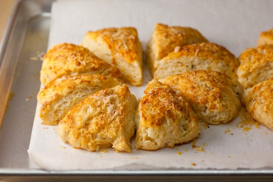 These savory cheddar scones made with buttermilk and brushed with smoked paprika butter are tender, flavorful, and easy to make. Perfect with soup or salad! pinchmysalt.com