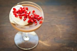Chocolate Hazelnut Panna Cotta with Whipped Cream and Pomegranate Arils