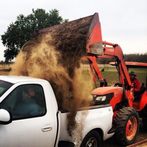 Picking up dirt from the ranch
