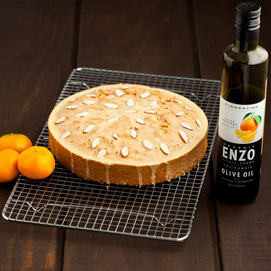 Citrus almond olive oil cake topped with citrus olive oil glaze and sliced almonds
