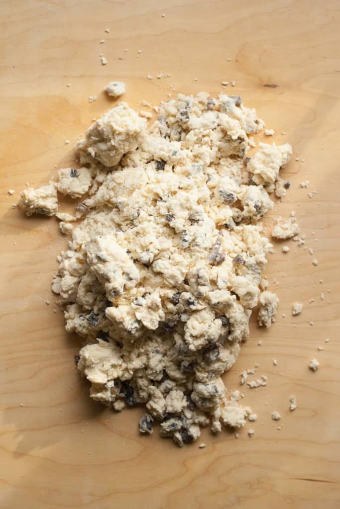 Fig scone dough dumped out onto kneading surface