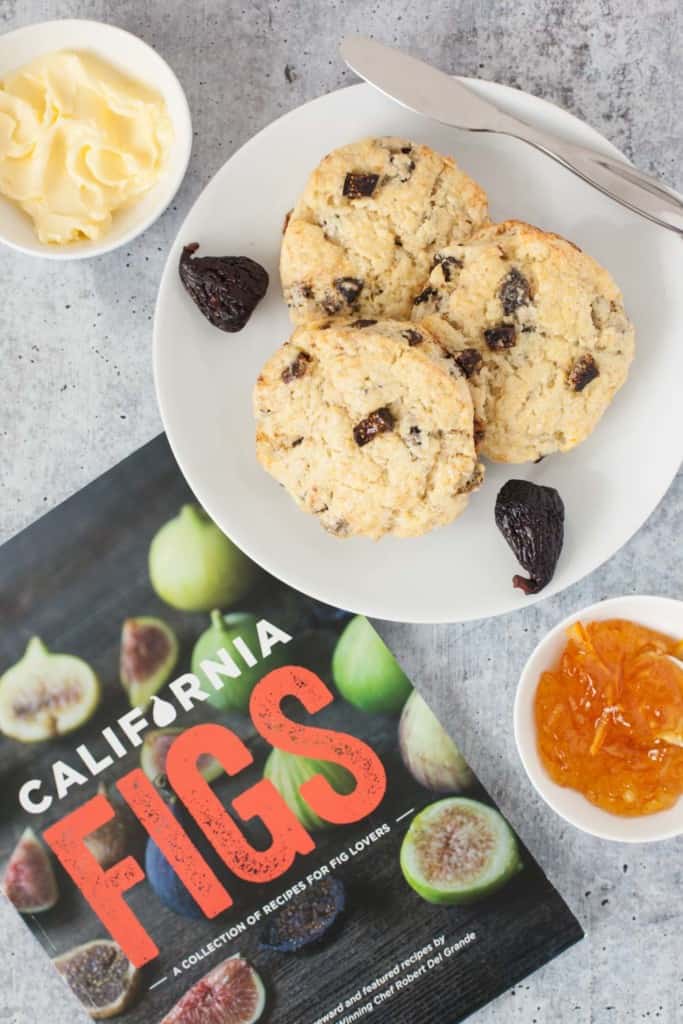 fig scones on a plate with butter and orange marmalade